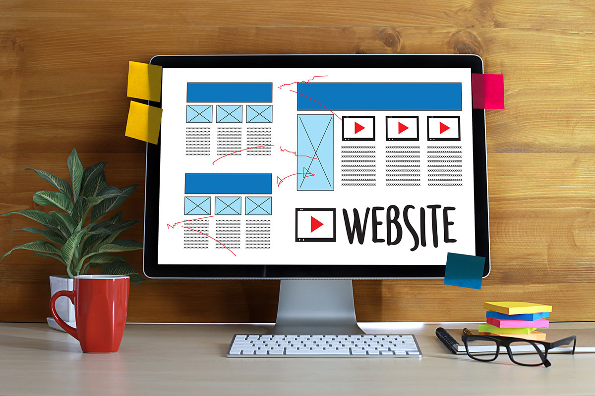 A drawing of a website blueprint being displayed on an imac