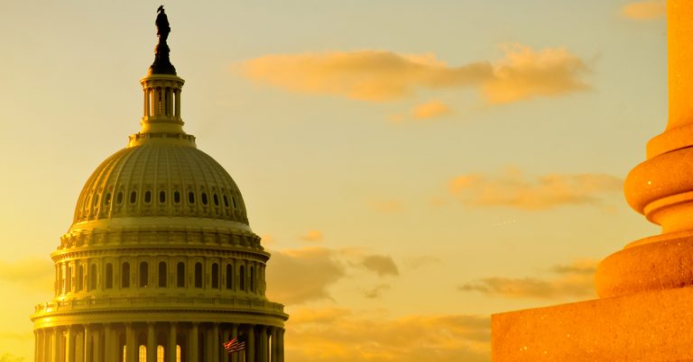 Photo of the United States Capital building roof during a sunset