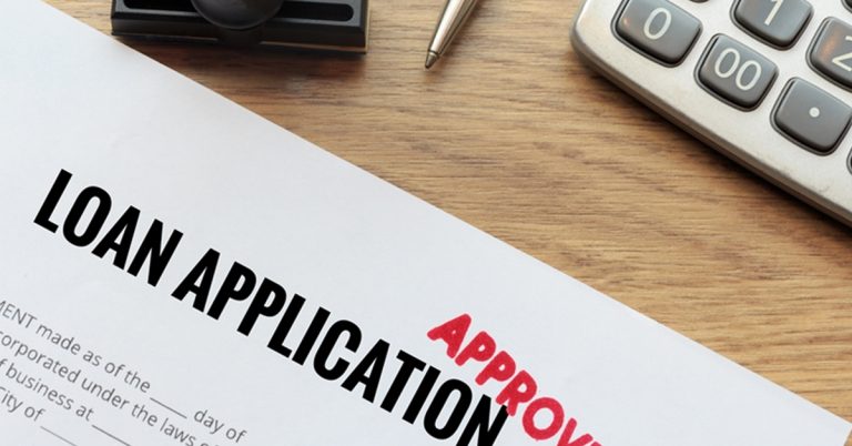 A loan Application with red stamp that says APPROVED