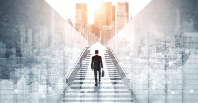 Photo montage with a businessman walking up stairs into a city skyline.