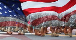 an overlay of the United states flag on top of army soldiers feet marching.